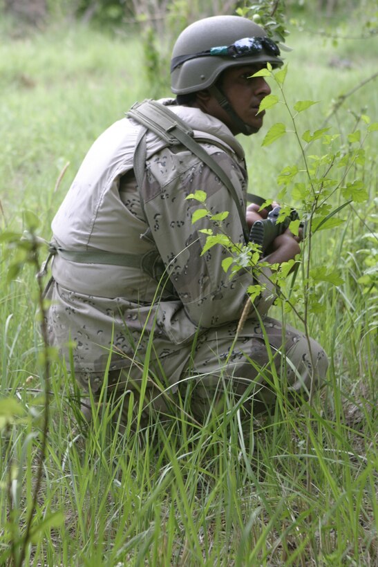 SAQLAWIYAH, Iraq - Pvt. Kaiser Mohssen Ali, a soldier with 2nd Company, 2nd Battalion, 2nd Regiment, 1st Brigade, stops during a patrol with Company A, 1st Battalion, 6th Marine Regiment personnel to provide security.  Iraqi Security Forces work closely with Company A personnel to conduct raids and patrols here as they provide security and stability to the residents of Saqlawiyah.