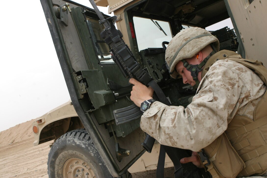 CAMP RAMADI, AR RAMADI, Iraq - Lance Corporal Brian Armstrong, a 21-year-old motor transportation operator with Truck Company, Headquarters Battalion, 2nd Marine Division, loads his M-16 A4 service rifle during a live fire and maneuver exercise, May 12, designed specifically to combat the insurgency.  U.S. Marine Corps photo by Sgt. Stephen D'Alessio (RELEASED)