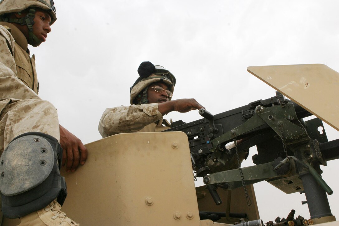 CAMP RAMADI, AR RAMADI, Iraq - Corporal Maurice Morrison, a 21-year-old Lithonia, Ga. native and motor transportation operator with Truck Company, Headquarters Battalion, 2nd Marine Division, hits targets with an M2 .50 Caliber Machine Gun from his humvee during a live fire and maneuver exercise, May 12, designed specifically to combat the insurgency.  Morrison is a 2002 graduate of Lithonia High School.  U.S. Marine Corps photo by Sgt. Stephen D'Alessio (RELEASED)
