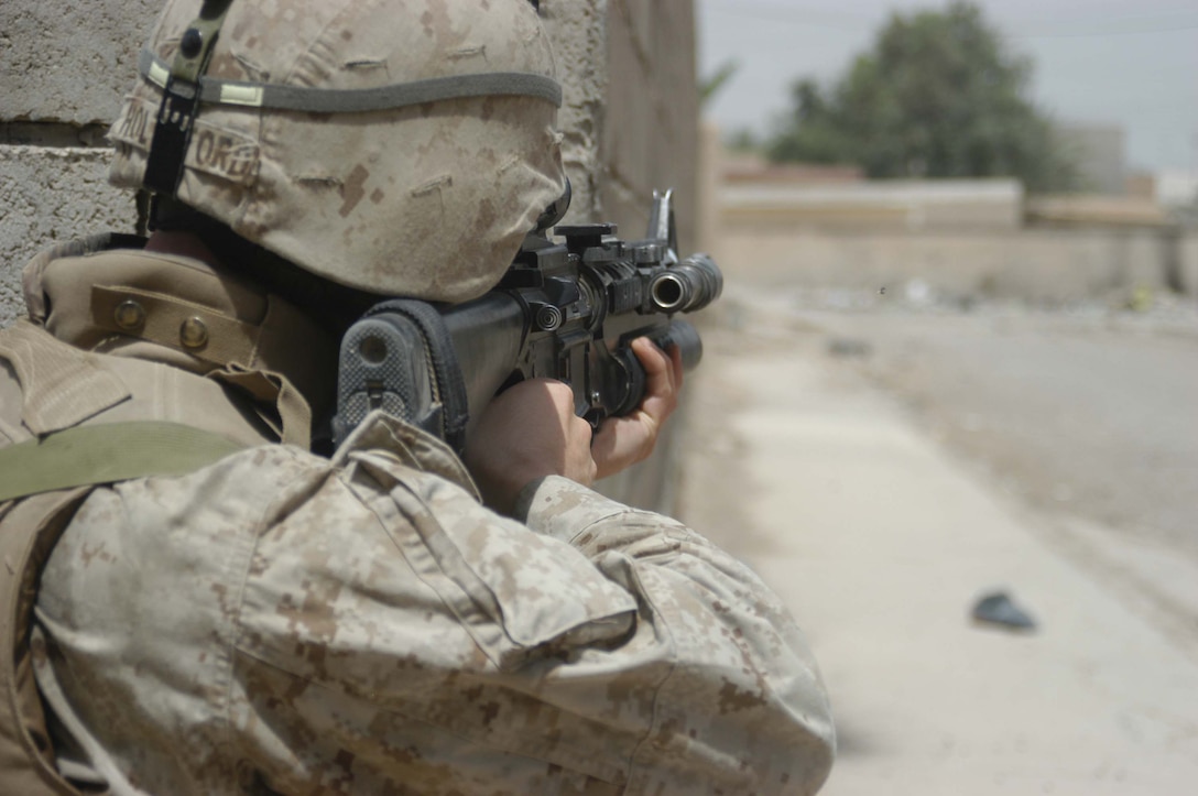 AR RAMADI, Iraq (May 13, 2005) - Lance Cpl. Ryan M. Holtsford, a rifleman with 2nd Squad, 2nd Platoon, Company B, 1st Battalion, 5th Marine Regiment, posts security down a street in the city here during a patrol. The 21-year-old Franklin, Tenn., native and his fellow 2nd Platoon warriors conducted a three-hour presence patrol through a portion of their company's area of operations notorious for insurgent activity. The Marines encountered sporadic machine gun fire from insurgents during their mission, which was geared toward disrupting enemy activity. The Marines accomplished their mission and returned to their firm base, Camp Ramadi, safely. Photo By: Cpl. Tom Sloan