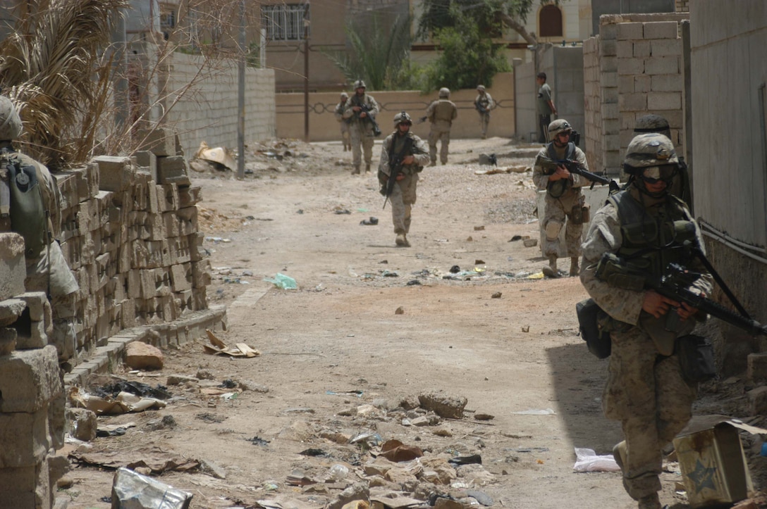 AR RAMADI, Iraq (May 13, 2005) -Marines with 2nd Platoon, Company B, 1st Battalion, 5th Marine Regiment, move through a street in the city here during a patrol. Warriors with 2nd Platoon conducted a three-hour presence patrol through a portion of their company's area of operations notorious for insurgent activity. The Marines encountered sporadic machine gun fire from insurgents during their mission, which was geared toward disrupting enemy activity. The Marines accomplished their mission and returned to their firm base, Camp Ramadi, safely. Photo By: Cpl. Tom Sloan