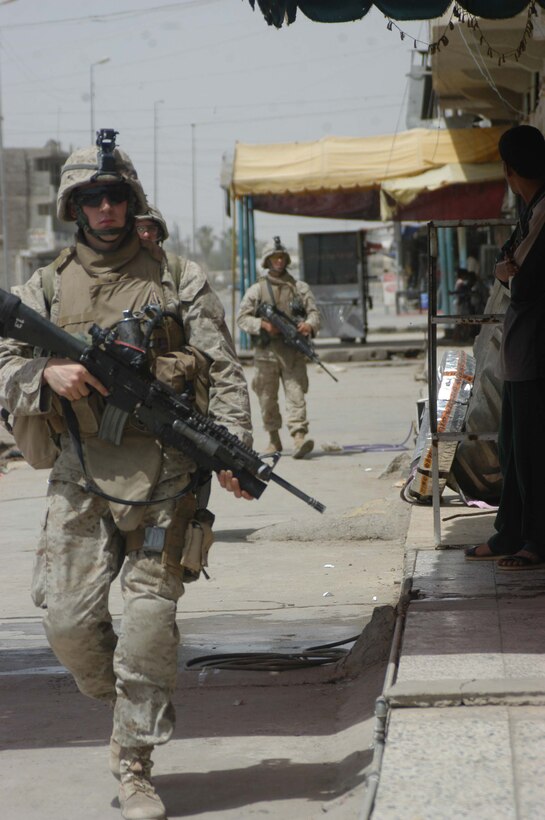 AR RAMADI, Iraq (May 13, 2005) - Lance Cpl. Ryan M. Holtsford, a rifleman with 2nd Squad, 2nd Platoon, Company B, 1st Battalion, 5th Marine Regiment, leads a tactical march along a city street here during a patrol. The 21-year-old Franklin, Tenn., native and his fellow 2nd Platoon warriors conducted a three-hour presence patrol through a portion of their company's area of operations notorious for insurgent activity. The Marines encountered sporadic machine gun fire from insurgents during their mission, which was geared toward disrupting enemy activity. The Marines accomplished their mission and returned to their firm base, Camp Ramadi, safely. Photo By: Cpl. Tom Sloan