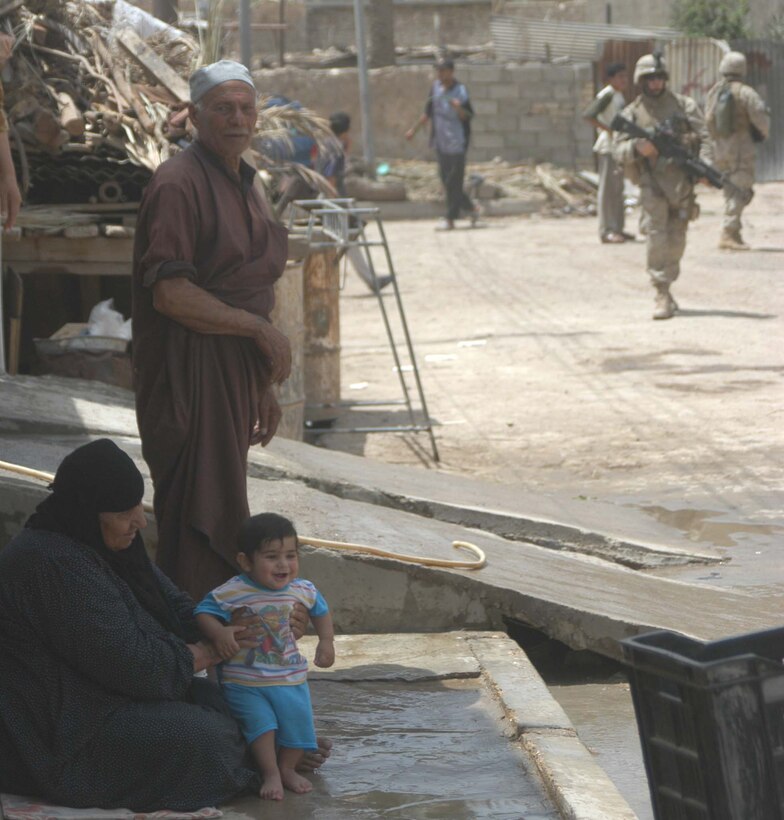 AR RAMADI, Iraq (May 13, 2005) - A young, Iraqi child smiles and laughs as Marines with 2nd Platoon, Company B, 1st Battalion, 5th Marine Regiment, patrol through her family's neighborhood here. Warriors with 2nd Platoon conducted a three-hour presence patrol through a portion of their company's area of operations notorious for insurgent activity. The Marines encountered sporadic machine gun fire from insurgents during their mission, which was geared toward disrupting enemy activity. The Marines accomplished their mission and returned to their firm base, Camp Ramadi, safely. Photo By: Cpl. Tom Sloan