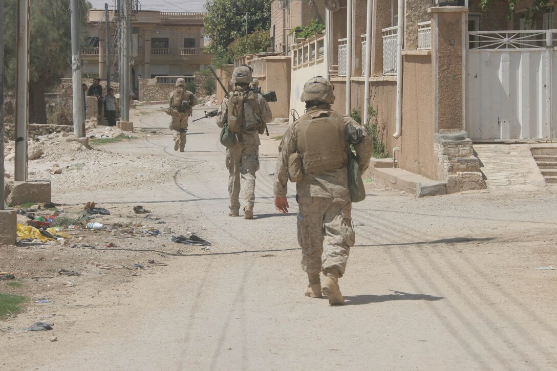 BANI DAHRI, Iraq ? Marines of 1st Squad, 3rd Platoon, K Company, 3rd Battalion, 2nd Marine Regiment, Regimental Combat Team 2, patrol through the city here during Operation Quick Strike.