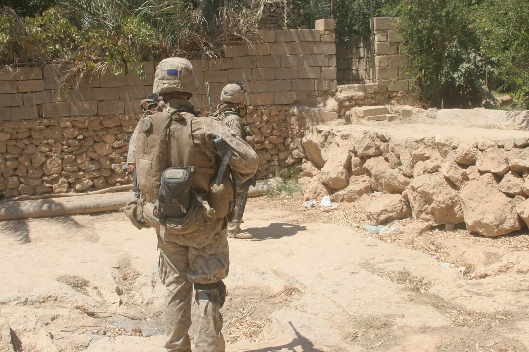 BANI DAHRI, Iraq ? Marines of 1st Squad, 3rd Platoon, K Company, 3rd Battalion, 2nd Marine Regiment, Regimental Combat Team 2, patrol through the city here during Operation Quick Strike.