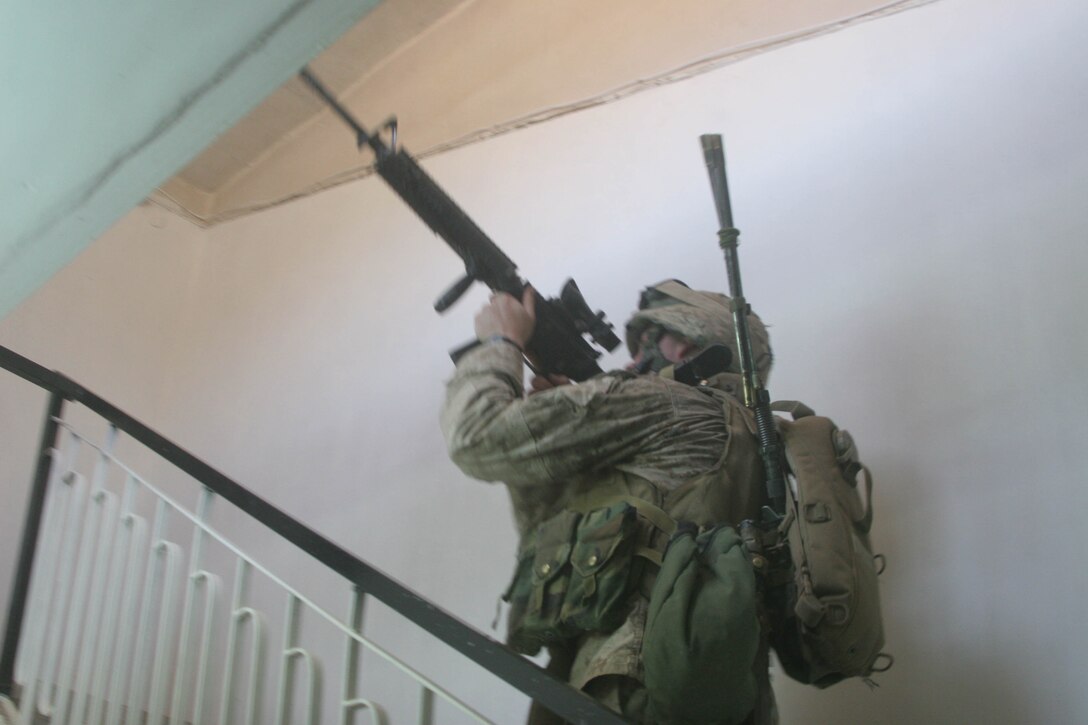 BANI DAHRI, Iraq - Lance Cpl. Chris L. LaFave, 19, from Arnold, Md., and a rifleman with 1st Squad, 3rd Platoon, K Company, 3rd Battalion, 2nd Marine Regiment, Regimental Combat Team 2 clears the second floor of an Iraqi house during Operation Quick Strike.