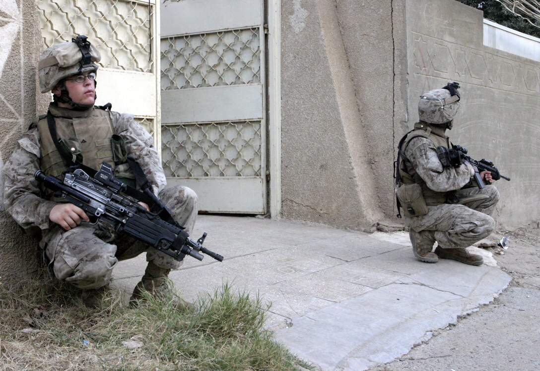 FALLUJAH, Iraq - Marines with 1st Platoon, Company C, 1st Battalion, 6th Marine Regiment, provide security outside a home here Aug. 13 during Operation Hard Knock.   The battalion's Marines and Iraqi Security Forces blocked off a sector of Northwestern Fallujah to search dozens of houses for weapons and to gather census information on the populace.
