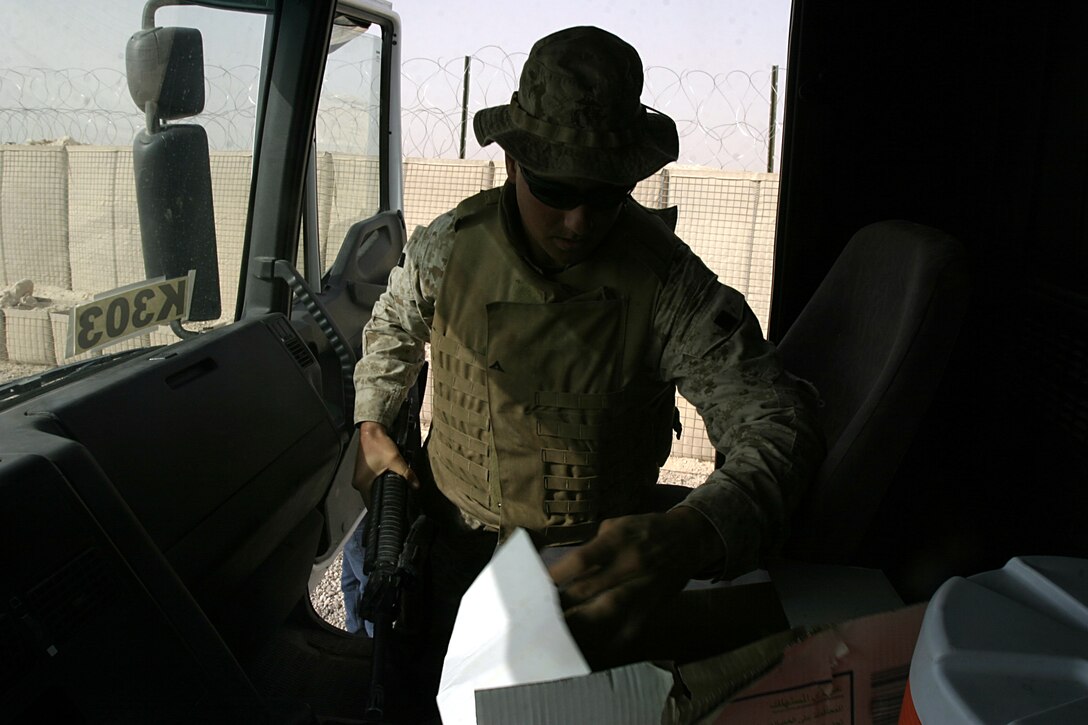 Camp Ripper, Iraq (August 13, 2005)-- Regimental Combat Team-2 guard force member Lance Cpl. David G. Weimortz, 28, a Columbia, S.C., native, searches a vehicle.  (Official USMC Photo by Corporal Ken Melton)