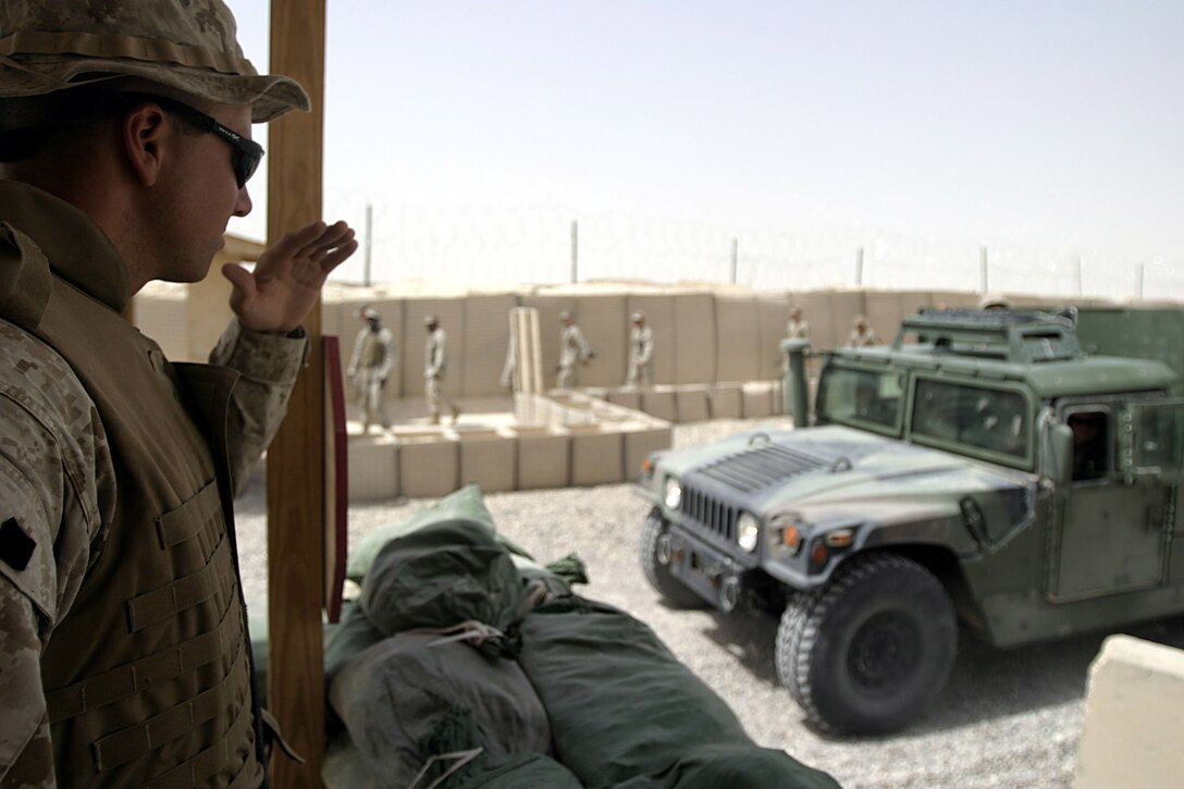 Camp Ripper, Iraq (August 13, 2005)-- Regimental Combat Team-2 guard force member Lance Cpl. David G. Weimortz, 28, a Columbia, S.C., native, waves a vehicle into Camp Ripper.  (Official USMC Photo by Corporal Ken Melton