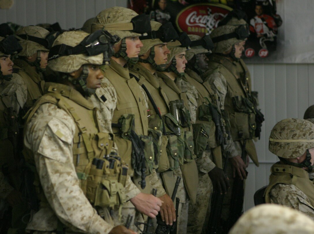 CAMP BLUE DIAMOND, AR RAMADI, Iraq - Marines, Sailors and Soldiers stand in formation, Oct. 13 during a ceremony for the 230th birthday of the Navy. Service members with the 2nd Marine Division celebrated the Navy's birthday with a traditional cake cutting ceremony.