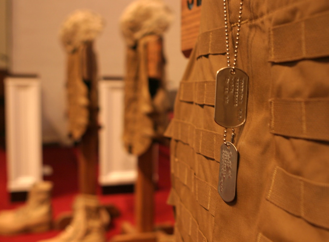 Marines from 2d Amphibian Assault Battalion gathered together in the base chapel today to mourn the loss of five Marines killed during their recent deployment.  Protective vests, boots and dog tags were arranged on the chapel stage to symbolize the fallen warriors.