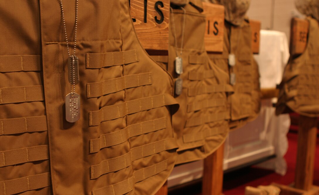 Marines from 2d Amphibian Assault Battalion gathered together in the base chapel today to mourn the loss of five Marines killed during their recent deployment.  Protective vests, boots and dog tags were arranged on the chapel stage to symbolize the fallen warriors.