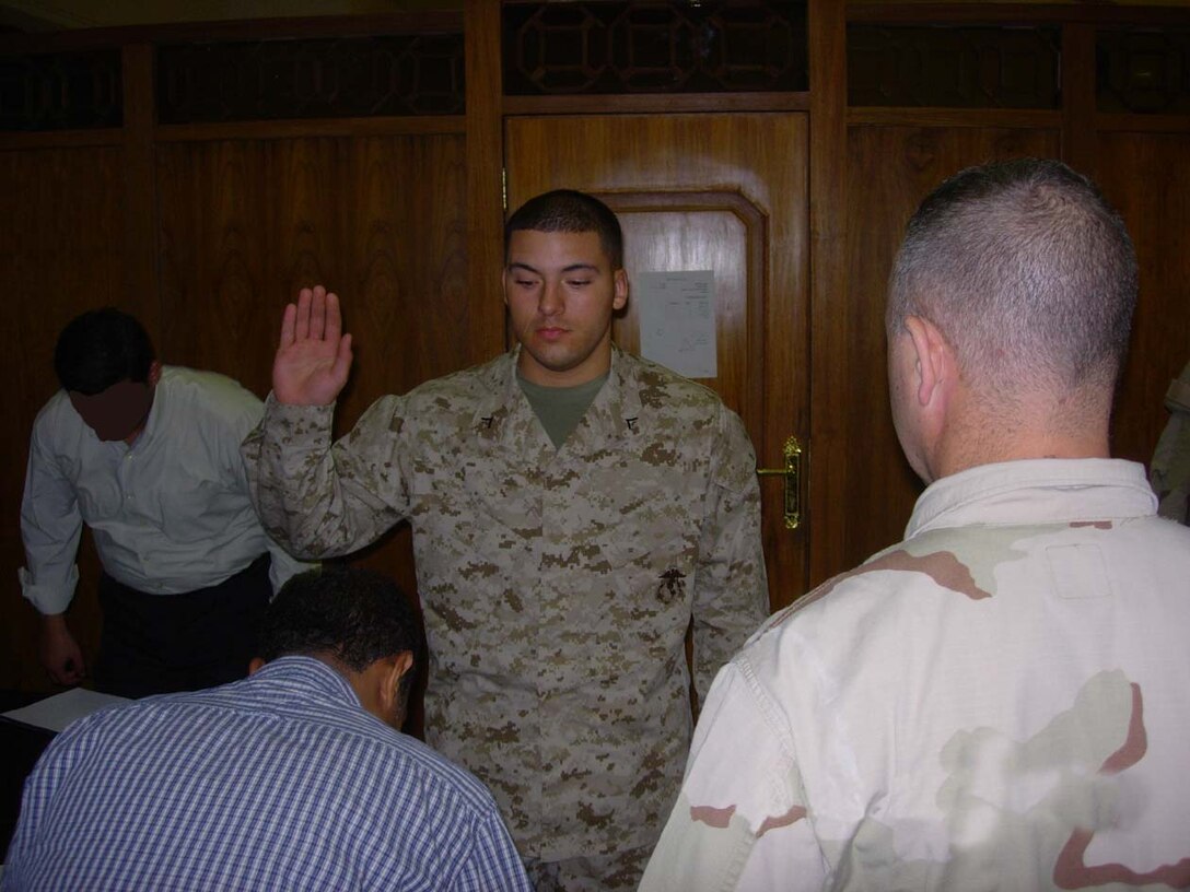 Baghdad, Iraq -- A Marine stands to be sworn in just before the hearing before an Iraqi judge in the Central Criminal Court of Iraq.  The Iraqi courts have adopted many of the American traditions, which usually take place in an American court system.  Photo Courtesy of Capt. Carlos Davila