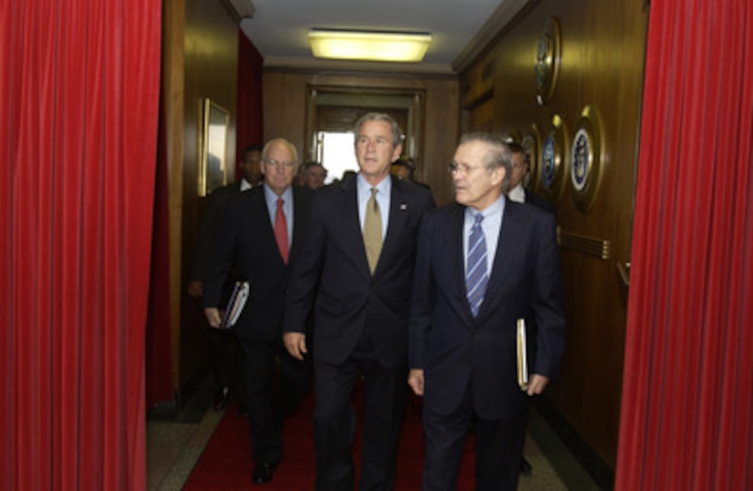 Secretary of Defense Donald H. Rumsfeld (right) escorts President George W. Bush and Vice President Dick Cheney to their meeting in the Pentagon on Jan. 13, 2005. Bush and Cheney were briefed on the tsunami relief efforts and the global war on terrorism. 