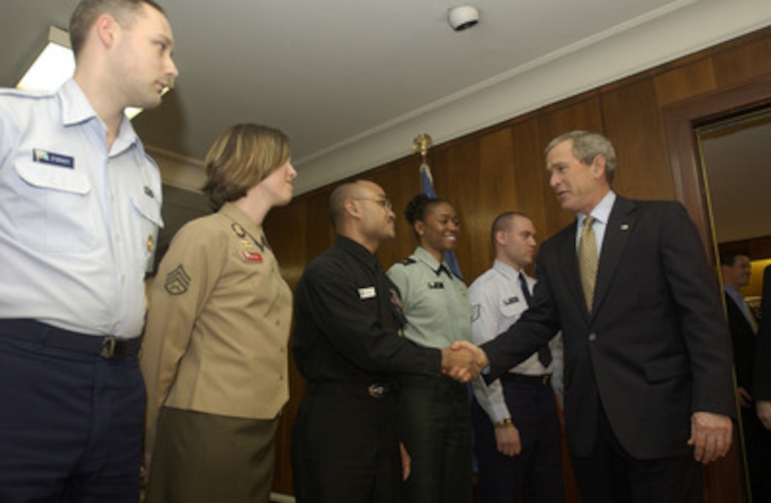 President George W. Bush shakes hands with Navy Petty Officer 2nd Class George Acffalle, of Guam, as he visits the Pentagon on Jan. 13, 2005. Bush and Vice President Dick Cheney received briefings by Secretary of Defense Donald H. Rumsfeld and his senior staff on the tsunami relief efforts of Operation Unified Assistance and the global war on terrorism. From left to right are Air Force Staff Sgt. Kevin O' Grady, of North Brunswick, N.J.; Marine Staff Sgt. Toye Hickman, of Piqua, Ohio; Acffalle; Army Sgt. Lesia Panda, of Cairo, Ill and Air Force Tech. Sgt. Darrell Archard, of Glens Falls. N.Y. 