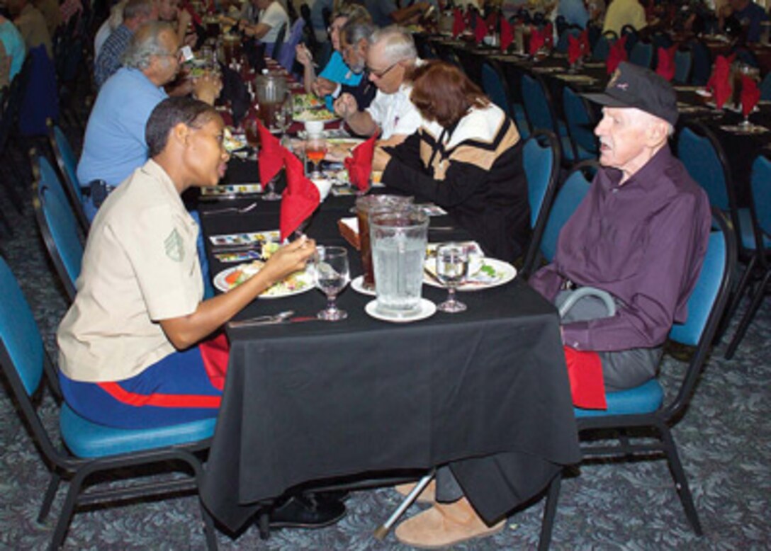 Staff Sgt. Lafawn Skipper, administration chief, enjoys lunch and conversation with retired Marine Kai Martin during the first Military Retiree Open House aboard MCLB Barstow. The event attracted more than 175 retirees from the High Desert area, who were invited for lunch, a tour of the base, an informational fair, a special evening colors ceremony and dinner.