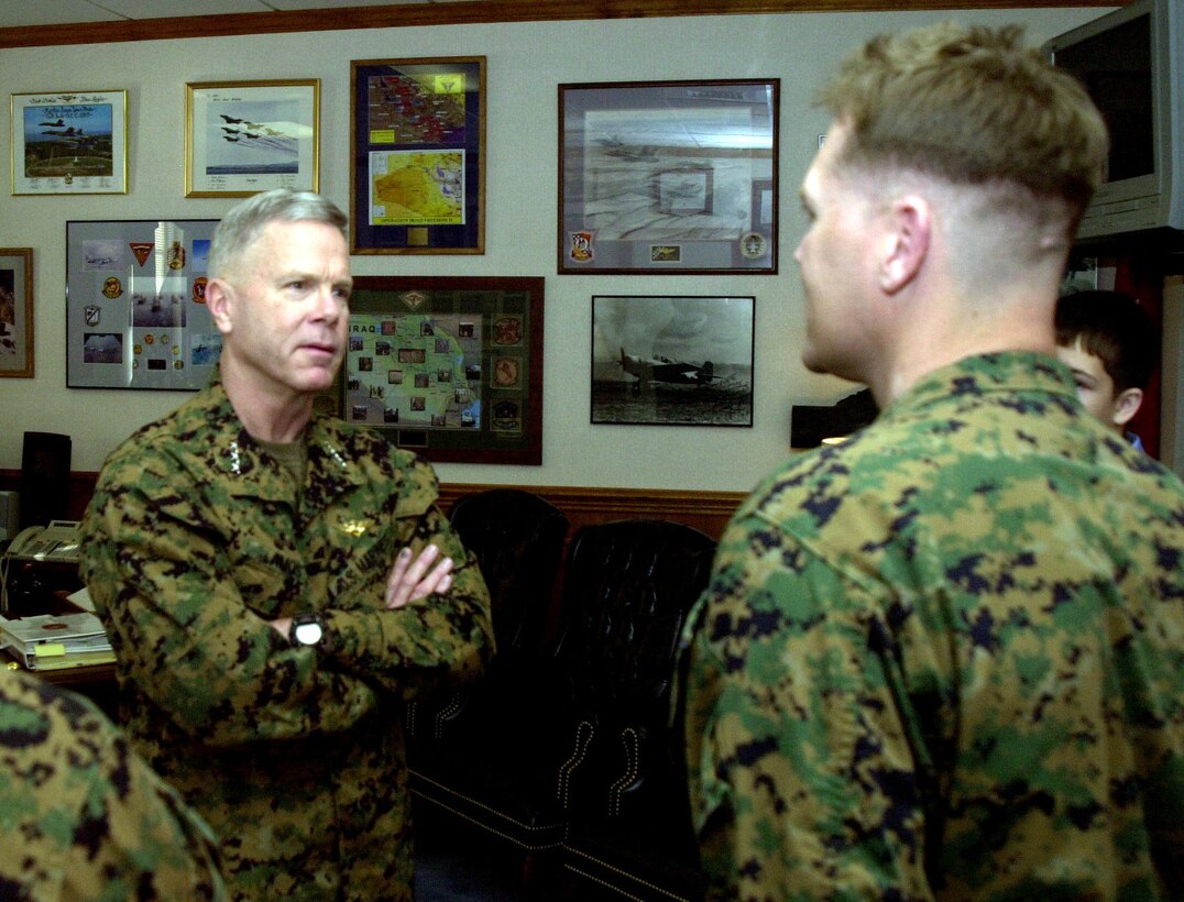 MARINE CORPS BASE CAMP LEJEUNE, N.C. - Lieutenant James F. Amos speaks with Chief Warrant Officer Philip R. before presenting him with a Bronze Star Medal Jan. 12 for his meritorious achievement while serving as Chief Technical Operations Officer while serving in Afghanistan during Operation Enduring Freedom. As a key member of the Human Intelligence Support Element, he discovered enemy weapons stockpiles, safe houses, smuggling routes and enemy fugitive command facilities during the battle against Al-Qaida and the Taliban. "I've gotten to award a few Bronze Stars in my life, but this one is one of the more important ones," said Amos. (Official Marine Corps photo by Lance Cpl. Shane Suzuki)