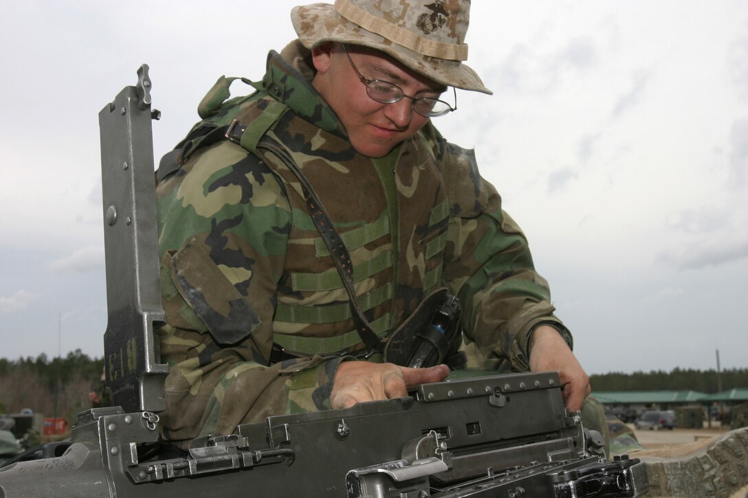 MARINE CORPS BASE CAMP LEJEUNE, N.C. (Feb. 14, 2004) - Lance Cpl. Mike C. Smalley, a Salt Lake City native and M1-A1 Tank driver cleans a .50-caliber machinegun after a training mission here recently. Smalley and 27 other Marine reservists, formerly from Company C, 4th Tank Battalion stationed in Boise, were recently activated and are currently in attached to 2nd Tank Battalion preparing to deploy in support of Operation Iraqi Freedom.
