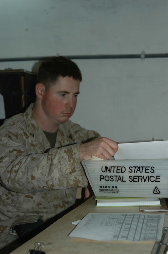 HURRICANE POINT, Ar Ramadi, Iraq (March 14, 2005) - Twenty-two-year-old Lance Cpl. Richard E. Beland from Garner, N.C., is the mail clerk for 1st Battalion, 5th Marine Regiment. The 2000 Garner Senior High School graduate is responsible for collecting, sorting and distributing mail to the more than 900 Marines in the infantry battalion. (Photo by Cpl. Tom Sloan)