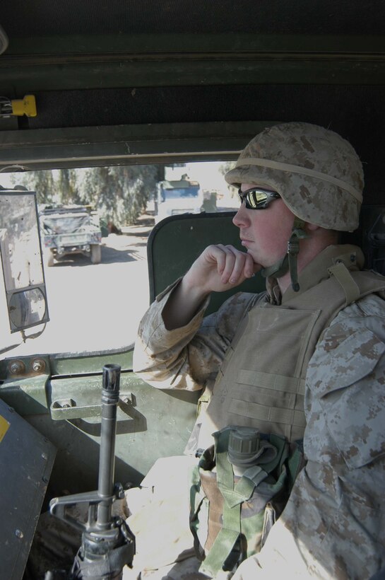 CAMP BLUE DIAMOND, Ar Ramadi, Iraq (March 14, 2005) -- Twenty-two-year-old Lance Cpl. Richard E. Beland from Garner, N.C., is the mail clerk for 1st Battalion, 5th Marine Regiment. Riding in a 7-Ton truck, he makes a mail run from Hurricane Point to pick up mail here. Convoys have suffered numerous attacks from improvised explosive devices on the route between Hurricane Point and Camp Blue Diamond. The 2000 Garner Senior High School graduate is responsible for collecting, sorting and distributing mail to the more than 900 Marines in the infantry battalion. (Photo by Cpl. Tom Sloan)
