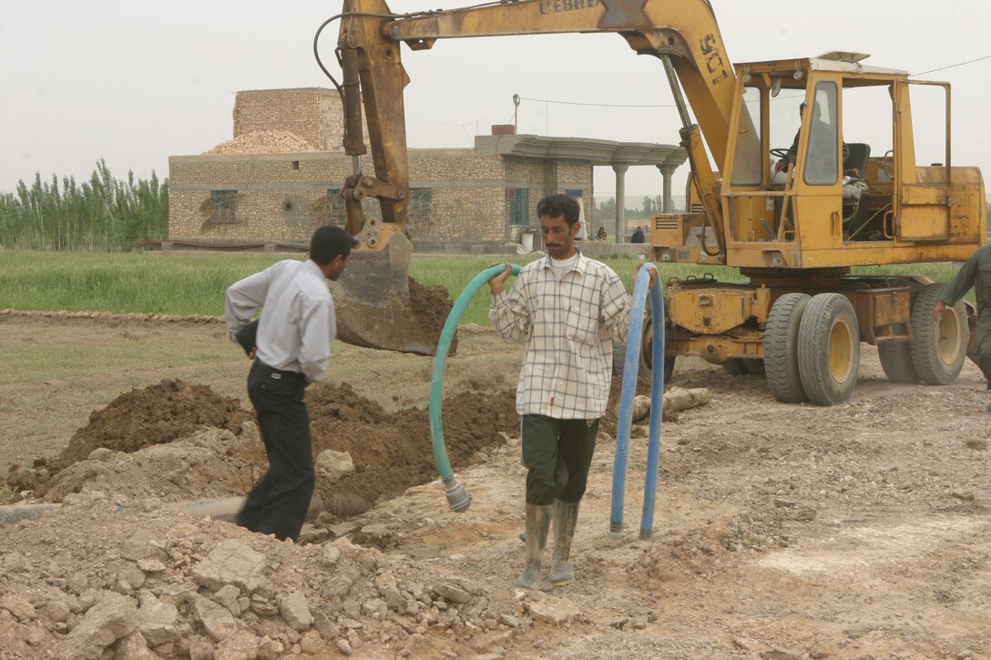 HUSAYBAH, Iraq (April 23, 2004)- Local Iraqi engineers begin work on a broken water line that helps supply the city and its 100,000 residents with water. The city and Camp Gannon, the Marine base located on the city's edge, were without water for a week.. With the help of a local sheik,Task Force 3/2's Civil Affairs Group organized the water line's repair. Official U.S. Marine Corps photo by Lance Cpl. Lucian Friel (RELEASED)