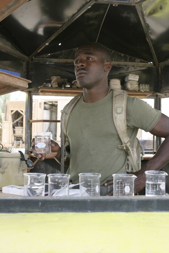 CAMP BAHARIA, Iraq - Lance Cpl. Daron Rice, hygiene equipment operator with 8th Engineer Support Battalion, II Marine Expeditionary Force and 19-year-old Detroit native, prepares to measure the chlorine level of a recently purified water sample here May 1.  Rice and his teammates are responsible for providing several military camps in the area with water by pumping and purifying tens of thousands of gallons everyday from the manmade lake here.