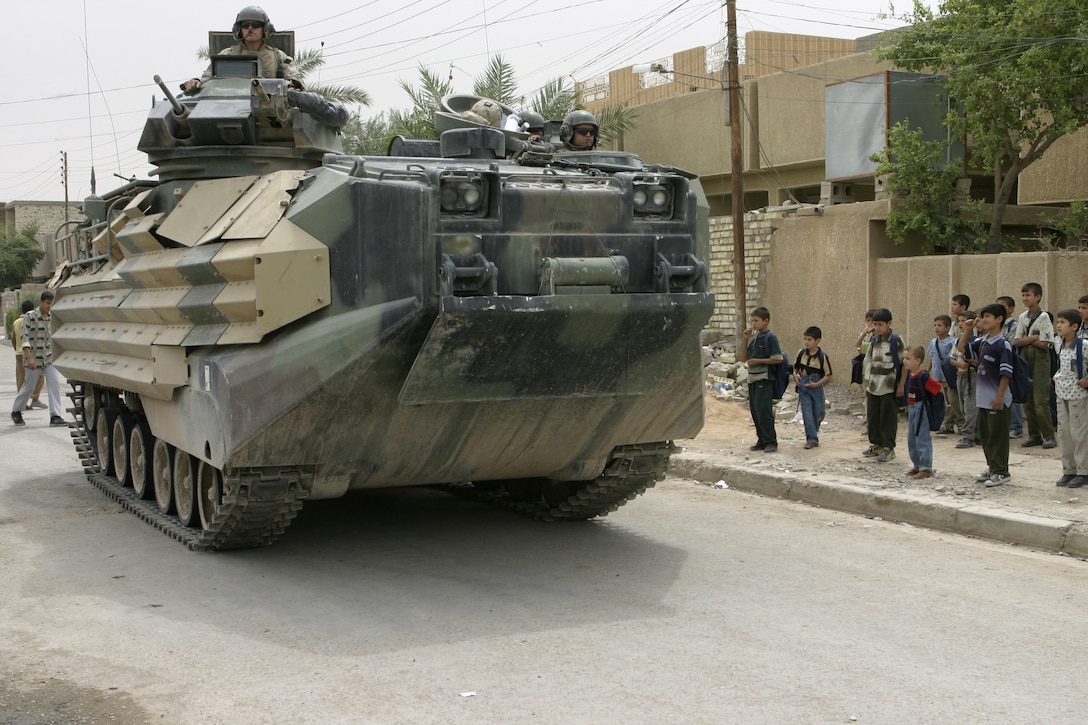 FALLUJAH, Iraq - An Amphibious Assault Vehicle rolls down the city streets while patrolling with Company B, 1st Battalion, 6th Marine Regiment personnel and Iraqi soldiers here May 4.  Iraqi Security Forces and Marines here visited local schools to distribute blackboards, school desks, and writing supplies as part of the ongoing joint civil-military mission, "Operation Blackboard."