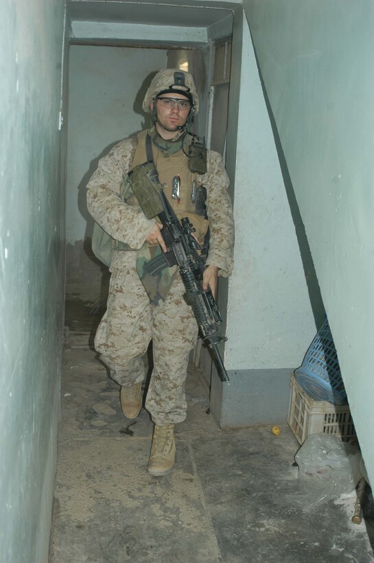 AR RAMADI Iraq (June 14, 2005) - Sergeant Derrek A. Brooks, a tow gunner with 1st Section, 1st Mobile Assault Platoon, Company W, 1st Battalion, 5th Marine Regiment, walks through a house here he and his comrades are searching during a mission. Insurgents attacked the 24-year-old from Martinsburg, W.V., and his fellow Marines with an improvised explosive device during a presence patrol they executed in the southern portion of the city. No one was hurt and no vehicles were damaged. Photo by: Cpl. Tom Sloan