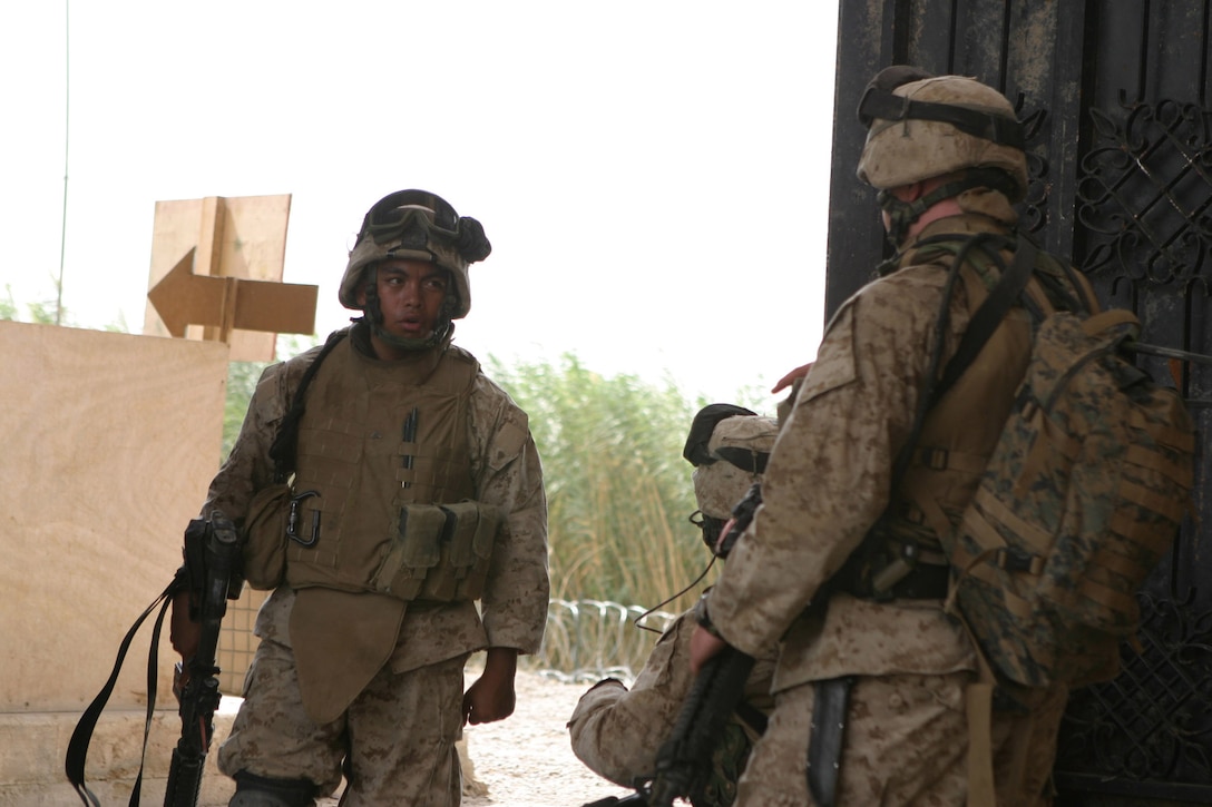CAMP BLUE DIAMOND, AR RAMADI, Iraq - Lance Cpl. Emmanuel Jumalon and other members of 3rd Platoon with the camp's guard force make their way back into the gate after a patrol in the area outside the wall, Aug. 14.  U.S. Marine Corps photo by Sgt. Stephen D'Alessio (RELEASED)