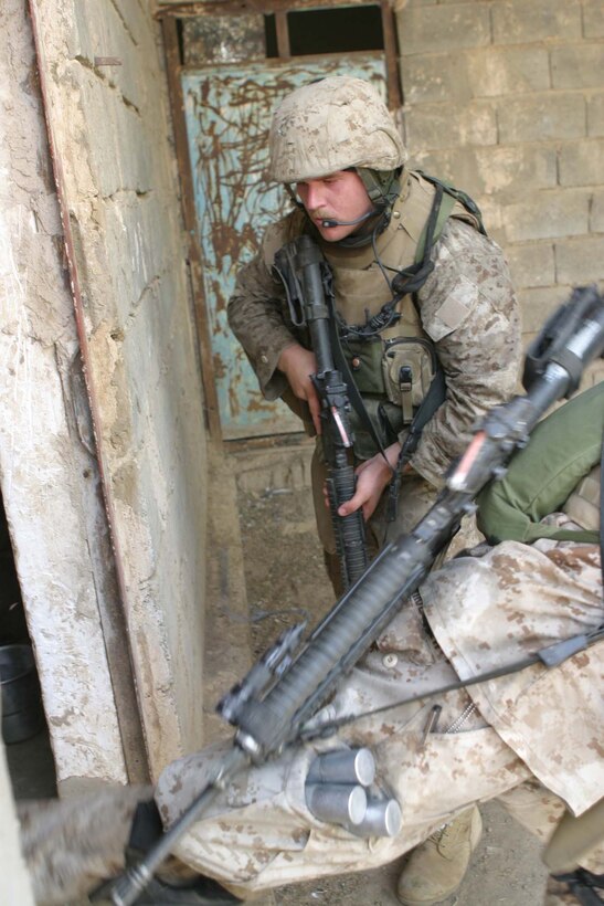 CAMP BLUE DIAMOND, AR RAMADI, Iraq - Marines with 3rd Platoon of the camp's guard force break into a suspected insurgent hideout while on patrol in the area outside the wall, Aug. 14.  U.S. Marine Corps photo by Sgt. Stephen D'Alessio (RELEASED)