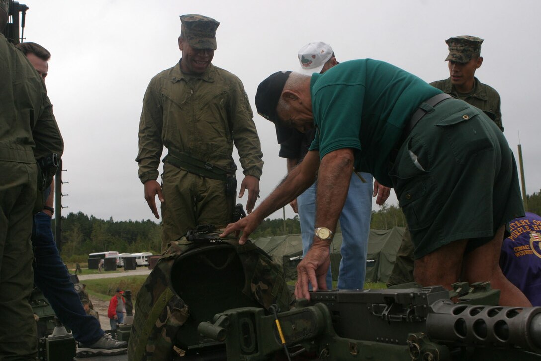 MARINE CORPS BASE CAMP LEJEUNE, N.C.(Oct. 14, 2005)- A Marine with 2nd Tank Battalion shows a former Marine with the Marine Corps Tank Association one of today's tanks after the Tankers of the Year Award ceremony at the SR-10 range here. (Official U.S. Marine Corps photo by Lance Cpl. Lucian Friel (RELEASED)