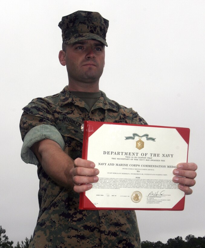 Gunnery Sgt. Jerome H. Murkerson, licensing chief, Truck Company, Headquarters Battalion, 2nd Marine Division, displays his Navy & Marine Corps Commendation Medal with Combat "V" citation he received here October 14. The Adger, Ala., native received the award in recognition of his counter-sniper and -insurgency activities in Ar Ramadi, Iraq, while platoon commander of 1st Platoon, Small Craft Co.