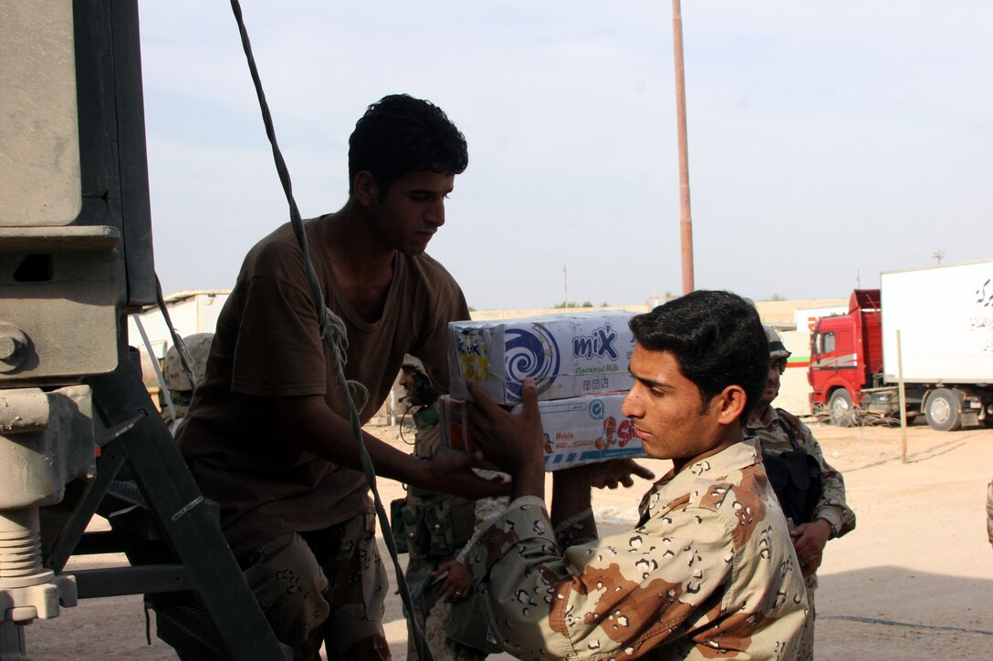 AR RAMADI, Iraq (Oct. 14, 2005) - Soldiers from the Iraqi Security Force load a truck with supplies in preparation for the national constitutional referendum vote Oct. 14.While Marines maintained security in the city, the ISF was responsible for securing the actual polling site. Photo by Cpl. Shane Suzuki