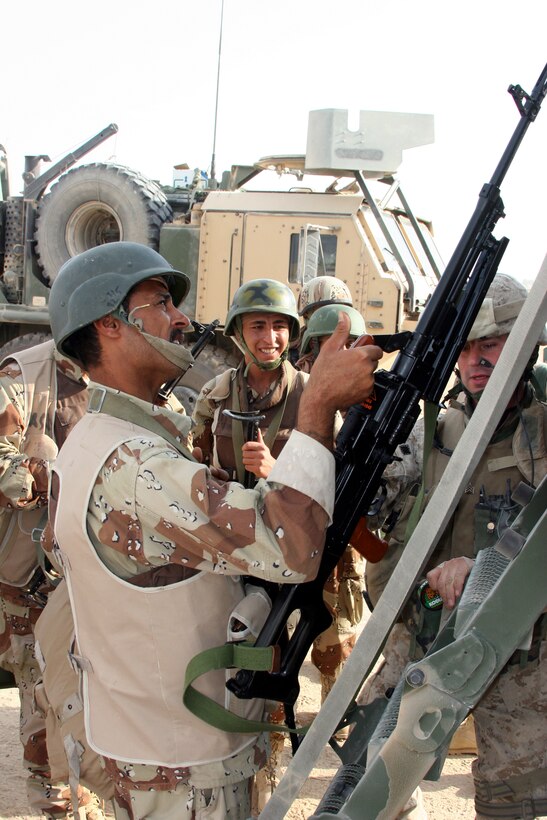 AR RAMADI, Iraq (Oct. 14, 2005) - Soldiers from the Iraqi Security Force load a truck with supplies in preparation for the national constitutional referendum vote Oct. 14.While Marines maintained security in the city, the ISF was responsible for securing the actual polling site. Photo by Cpl. Shane Suzuki