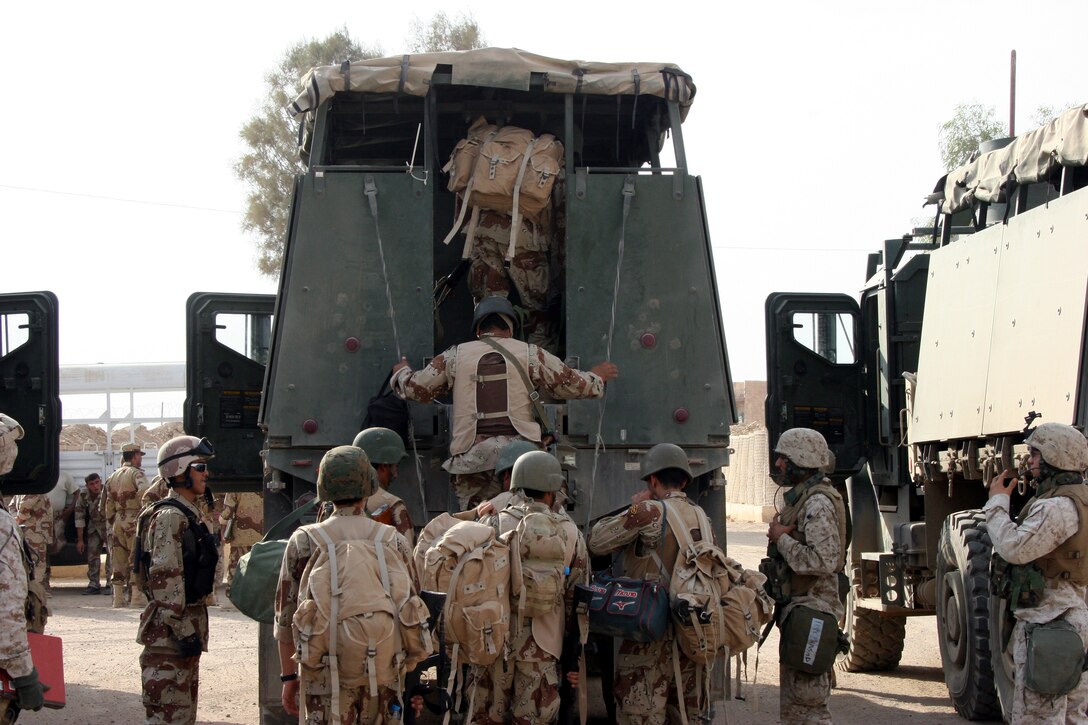 AR RAMADI, Iraq (Oct. 14, 2005) - Soldiers from the Iraqi Security Force climb into a truck that will take them to their assigned polling station during the national constitutional referendum vote Oct. 14.While Marines maintained security in the city, the ISF was responsible for securing the actual polling site. Photo by Cpl. Shane Suzuki