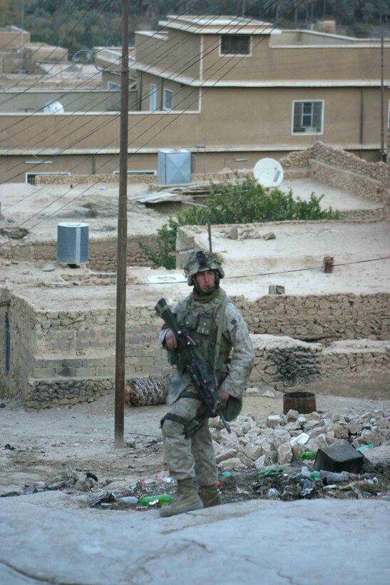 HAQLANIYAH, Iraq (Nov. 27, 2005)  - Woodland, Calif. native, Lance Cpl. Chris P. Stabler, looks back to his team during a security patrol here Nov. 27. Stabler, a team leader with India Company, 3rd Battalion, 1st Marine Regiment, performs patrols in the city almost everyday with Iraqi Army soldiers to show a presence and keep the insurgency out of the quiet city. (Official Marine Corps photo by Cpl. Adam C. Schnell)