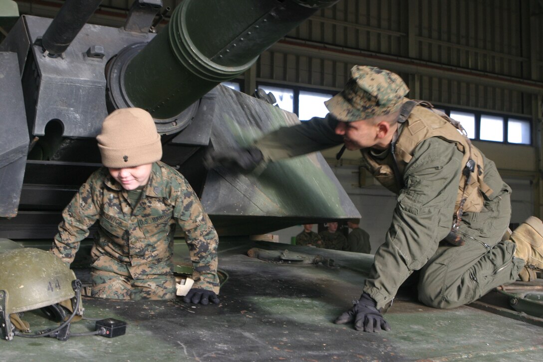 MARINE CORPS BASE CAMP LEJEUNE, N.C. (Dec. 14, 2005)- Six-year-old Brandon Rasnick gets into the driver's seat of an M1A1 Abrams Battle Tank. Brandon made a wish to train with Marines and save the world and thanks to the Marines of 2nd Tank Battalion that wish came true. (Official U.S. Marine Corps photo by Lance Cpl. Lucian Friel (RELEASED)