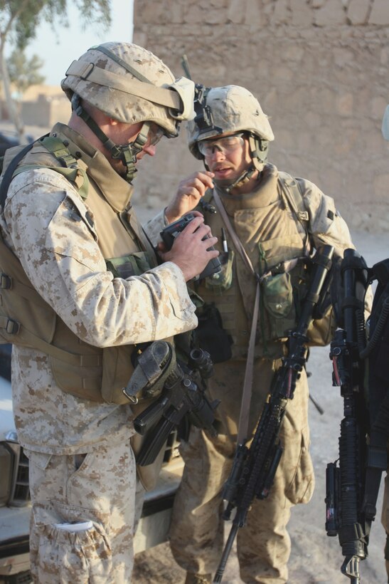 Cpl. Chris W. Adair gives a description of a video recorder found by his squad during a patrol to his Platoon Commander, 2ndLt. Ernest P. Abelson