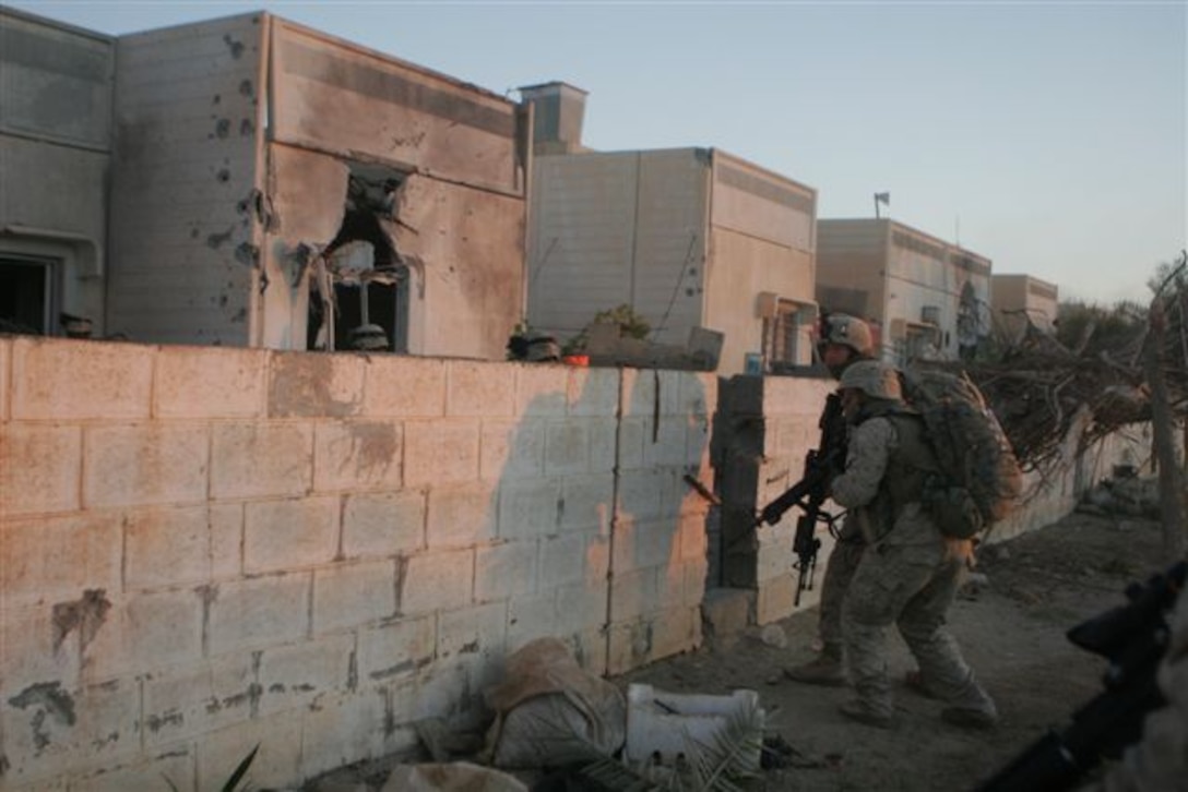 UBAYDI, Iraq ? Marines move into the first row of houses after facing down insurgent fire Nov. 14. The Marines assigned to 3rd Platoon, Company E, 2nd Battalion, 1st Marine Regiment, participated in Operation Steel Curtain against insurgents here and within other border towns on the Lower Euphrates River Valley recently.