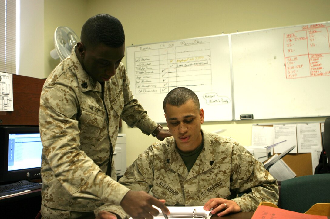 MARINE CORPS BASE CAMP LEJEUNE, N.C. (February 14, 2005) - Sergeant Acquil S. Wilson, the supply operations noncommissioned officer in charge for 2d Marine Division works with Cpl. Jamaal E. Alexander, checking the daily supply operations within the Division.