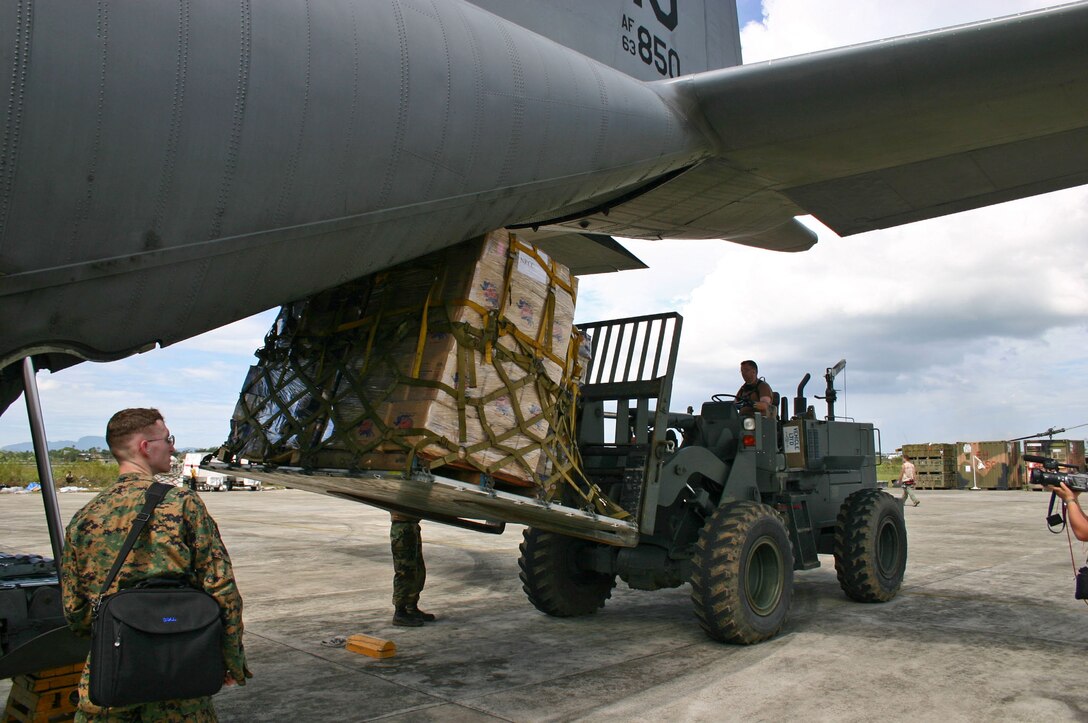 BANDA ACEH, Indonesia -- A pallet of water is unloaded from a C-130 Hercules here Jan. 10.  More than 18,000 Marines, Sailors, Airmen, Soldiers and Coast Guardsmen with Combined Support Force 536 are working with international militaries and nongovernmental organizations to aid the affected people of Thailand, Sri Lanka and Indonesia after a magnitude 9.0 earthquake Dec. 26 triggered devastating tsunamis.  International efforts to minimize suffering and mitigate loss of life continue as the CSF 536 servicemembers provide humanitarian assistance supporting Operation Unified Assistance.  (U.S. Air Force photo by 2nd Lt. Ben Sakrisson)