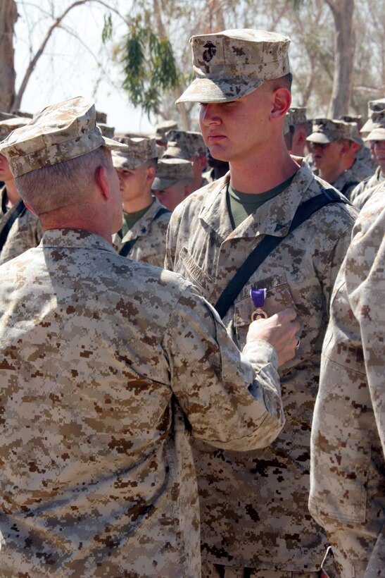 CAMP FALLUJAH, Iraq -- Major General Richard A. Huck, 2nd Marine Division Commanding General visited 3rd Battalion, 8th Marine Regiment  presented Lance Cpl. Vincent Hawkins with his Purple Heart.  Huck also spoke to the Marines about the job they have been doing so far.  Official U.S. Marine Corps photo by Lance Cpl. Athanasios L. Genos