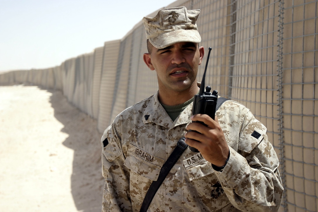 Al Asad, Al Anbar, Iraq (July 10, 2005)--Cpl. Ahmad M. Ibrabim, 27, of Philadelphia, Penn. and RCT-2 Jump Team's linguist conducts a radio check. (Official USMC Photo by Corporal Ken Melton)