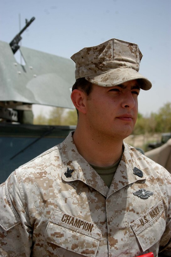 CAMP HURRICANE POINT Ar Ramadi, Iraq (July 15, 2005) - Paul W. Champion, 25, of Iron Mountain, Mich., was meritoriously promoted to the rank of petty officer 2nd class during a ceremony here July 15. The hospitalman and the senior line corpsman for Company A, 1st Battalion, 5th Marine Regiment, was one of only two Sailors selected to pin on the rank meritoriously while serving in combat, under the Navy's newly mandated Combat Meritorious Advancement Program. Champion has been a corpsman for three and a half years and has served with 1st Battalion, 5th Marines for two years. He received a Navy Commendation medal with combat V device for his actions in Fallujah on April 7, 2004 with Camp Pendleton, Calif., based infantry battalion. Champion graduated from Kingsford High School in 1999 and has an Associates degree in Criminal Justice for Northern Michigan University. Photo by: Cpl. Tom Sloan