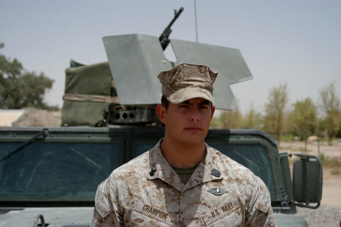 CAMP HURRICANE POINT Ar Ramadi, Iraq (July 15, 2005) - Paul W. Champion, 25, of Iron Mountain, Mich., was meritoriously promoted to the rank of petty officer 2nd class during a ceremony here July 15. The hospitalman and the senior line corpsman for Company A, 1st Battalion, 5th Marine Regiment, was one of only two Sailors selected to pin on the rank meritoriously while serving in combat, under the Navy's newly mandated Combat Meritorious Advancement Program. Champion has been a corpsman for three and a half years and has served with 1st Battalion, 5th Marines for two years. He received a Navy Commendation medal with combat V device for his actions in Fallujah on April 7, 2004 with Camp Pendleton, Calif., based infantry battalion. Champion graduated from Kingsford High School in 1999 and has an Associates degree in Criminal Justice for Northern Michigan University. Photo by: Cpl. Tom Sloan
