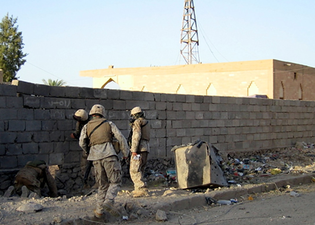 Hit, Al Anbar, Iraq (July 15, 2005)-Marines with Weapons Platoon investigate the area in which a IED exploded outside a mosque. (Official USMC Photo by Corporal Erik P. Brinker)