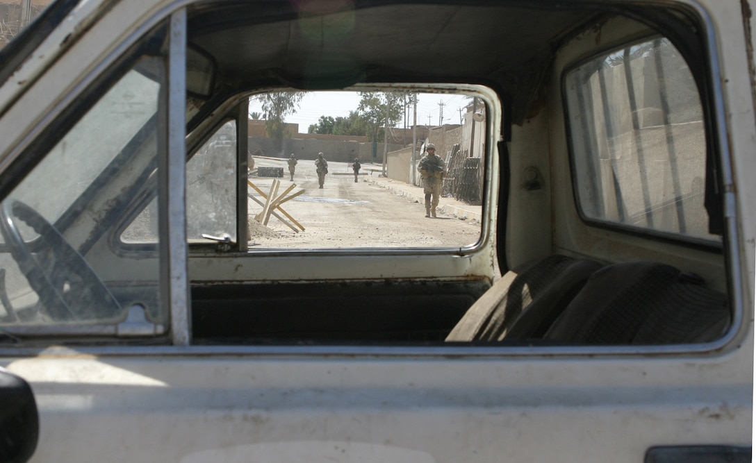 HIT, Iraq (Sept. 15, 2005)  -Marines with India Company, 3rd Battalion, 1st Marine Regiment patrol the streets here Sept. 15. The Marines and ISF soldiers perform patrols in the area daily to better stabilize the area. (Official Marine Corps photo by Cpl. Adam C. Schnell)