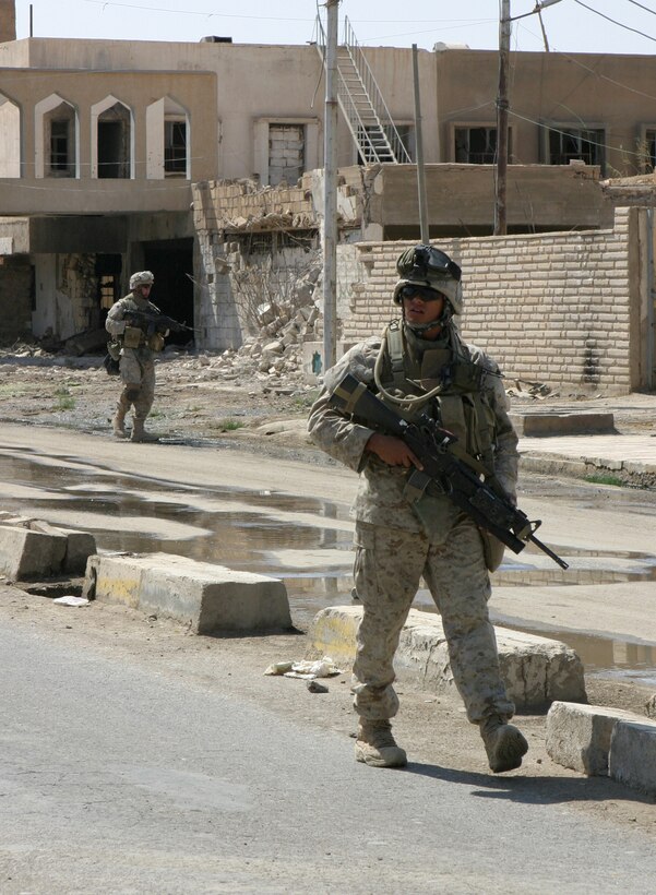 HIT, Iraq (Sept. 15, 2005)  -Marines with India Company, 3rd Battalion, 1st Marine Regiment patrol the streets here Sept. 15. The Marines and ISF soldiers perform patrols in the area daily to better stabilize the area. (Official Marine Corps photo by Cpl. Adam C. Schnell)