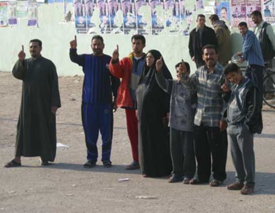 Iraqi?s proudly display ink stained fingers in the city of Fallujah Dec. 15. They were voting in a historic parliamentary election. After largely boycotting the election for the constitutional referendum in October, the largely Sunni population of Fallujah turned out in large crowds to vote.