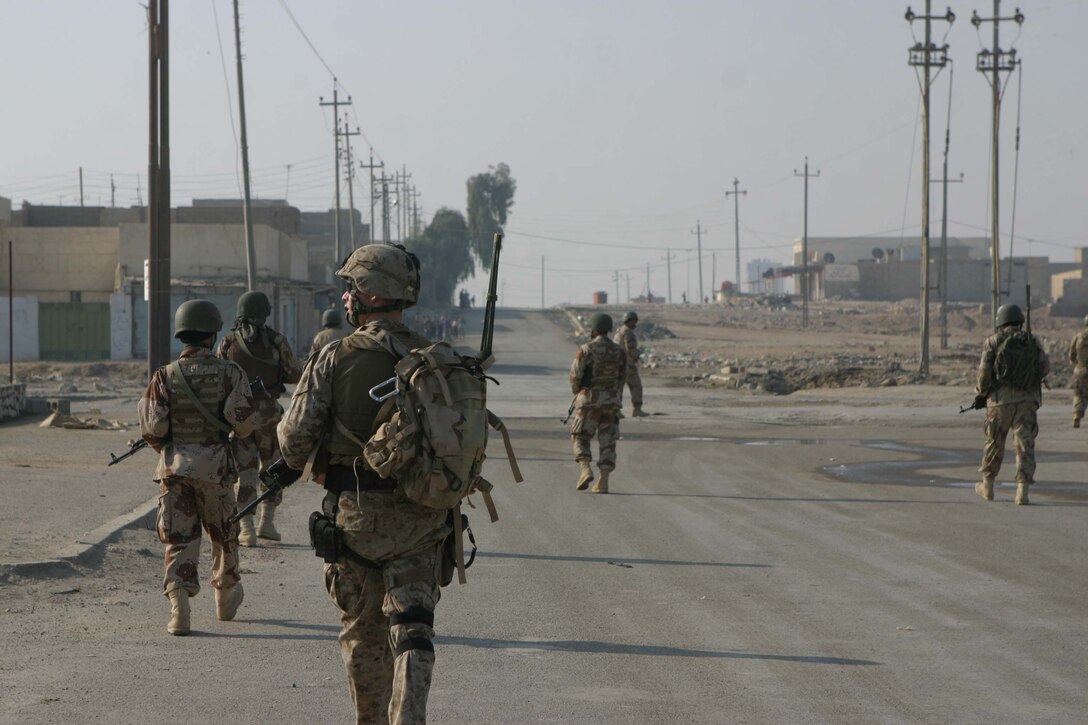 RAMADI, Iraq -  Iraqi soldiers patrol the streets of Tammim in Ramadi here Dec 15. Iraqi soldiers accompanied by their U.S. military advisors provided a presence on the streets during Al Anbars provincial elections. Official U.S. Marine Corps photo by Sgt. Ryan S. Scranton